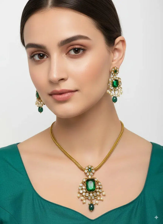 Woman wearing emerald green jewelry set with necklace and earrings on a white background