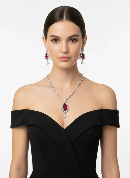 Red Stone CZ Necklace Set with Earrings worn by a model, showcasing a bold teardrop red gemstone and sparkling CZ stones.