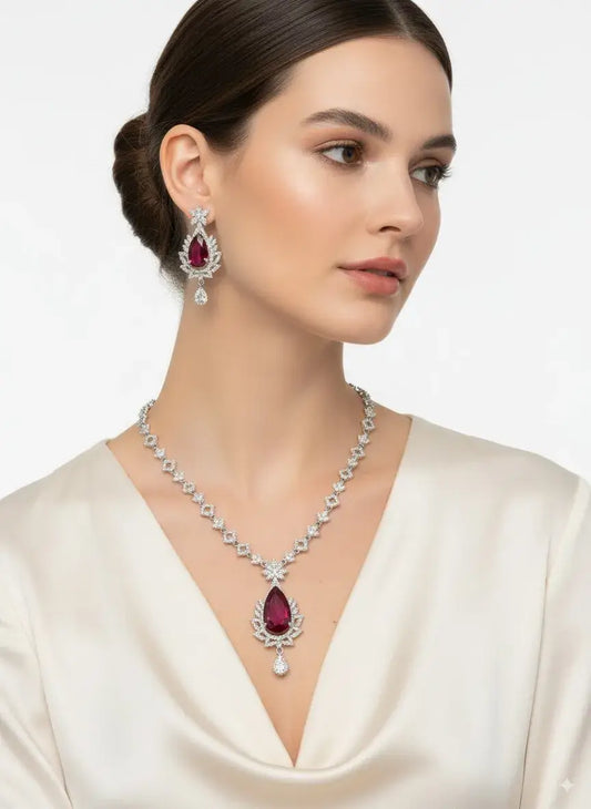 Red Stone CZ Necklace Set with Earrings worn by a model, featuring a bold teardrop red gemstone and sparkling CZ accents.