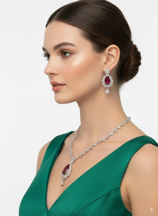 Red Stone CZ Necklace Set with Earrings showcased on a model wearing a green dress, highlighting the stunning red gemstone.