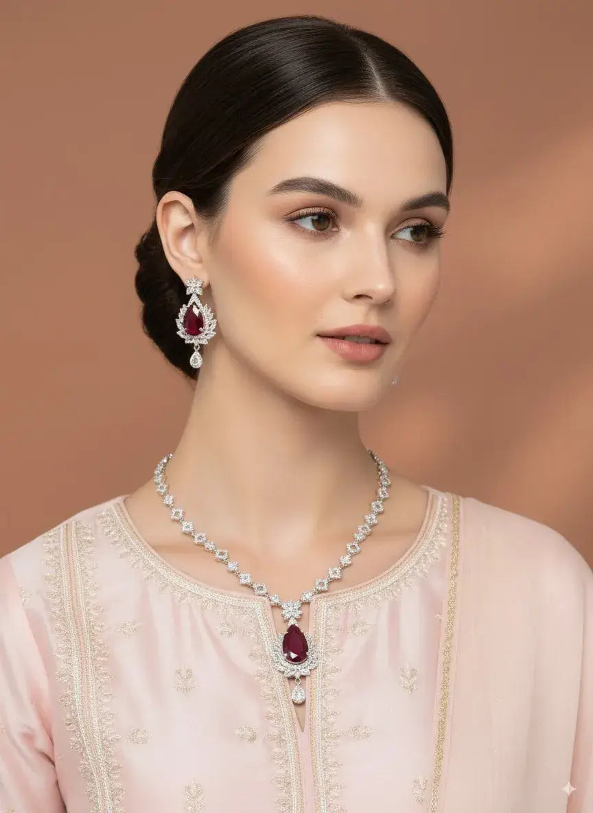 Red Stone CZ Necklace Set with Earrings worn by a model, featuring a bold teardrop red gemstone and matching earrings.