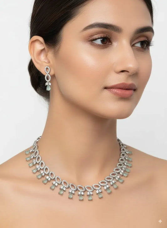 Pastel Green Silver CZ Necklace Set with Earrings displayed on a model, showcasing pastel green teardrop stones and silver detailing.