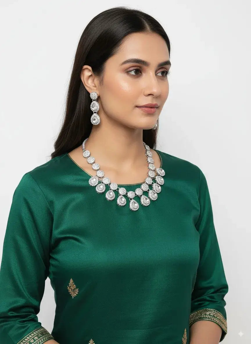 royal cz diamond drop necklace set with earrings worn by a model in green attire.