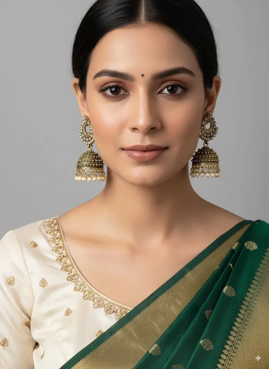 gold-plated pearl jhumka earrings – traditional ethnic wedding jewellery worn with a green and gold saree.