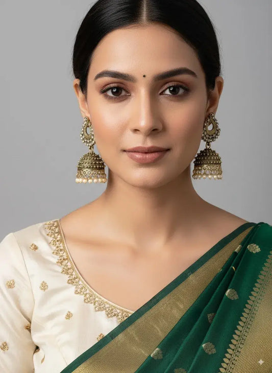 Antique Gold-Plated Pearl Jhumka Earrings – Traditional Bridal Jewellery worn with an elegant saree.