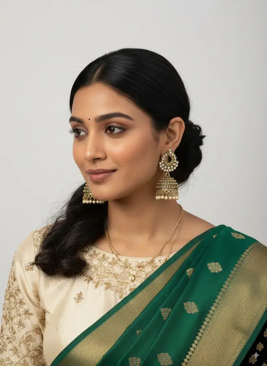 Antique Gold-Plated Pearl Jhumka Earrings – Traditional Bridal Jewellery worn by a model with a green saree.