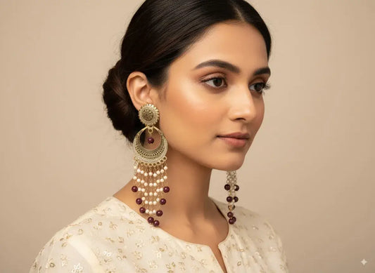 Antique Gold Long Chandelier Earrings with Pearls & Maroon Beads – Bridal & Festive Jewellery worn by woman.