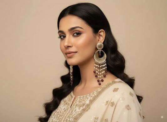 Antique Gold Long Chandelier Earrings with Pearls & Maroon Beads – Bridal & Festive Jewellery worn by a model.