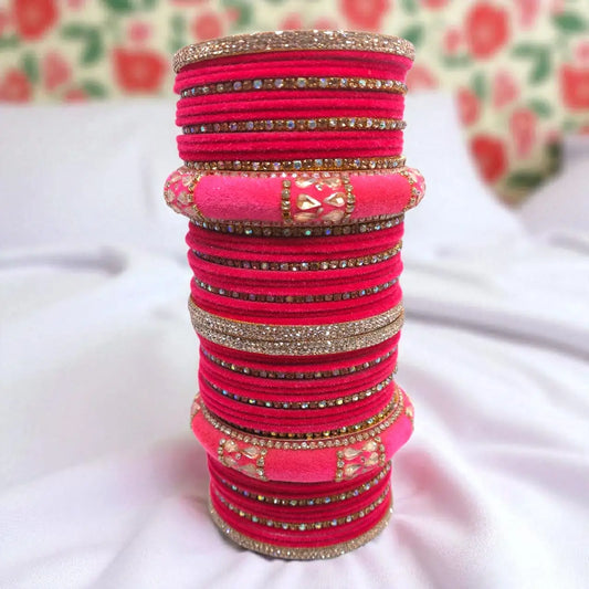 Stack of pink hair ties with decorative elements on a white surface