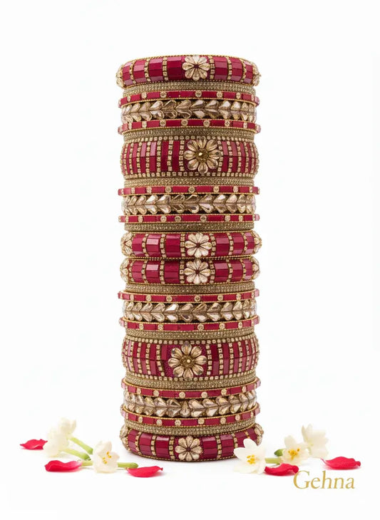Red Gold Bridal Bangle Set – 26 Piece Kundan & Stone Work displayed elegantly with flowers.
